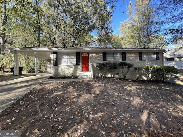 4906 Springbrook Dr, Douglasville, GA 30135 - view of front facade with brick siding, an attached carport, and concrete driveway