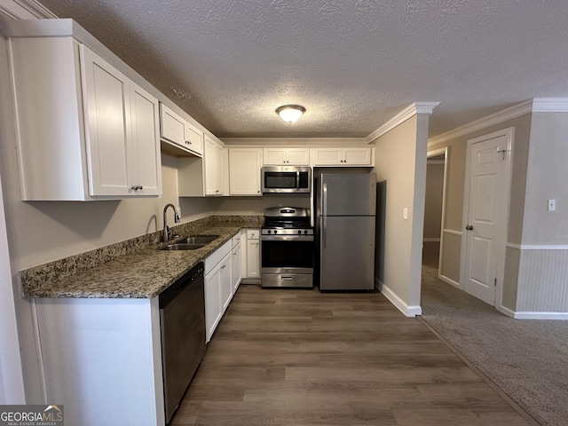 4906 Springbrook Dr, Douglasville, GA 30135 - kitchen with stainless steel appliances, white cabinets, dark wood finished floors, a textured ceiling, and dark stone counters