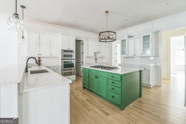 kitchen with white cabinets, light wood-type flooring, stainless steel appliances, and green cabinets