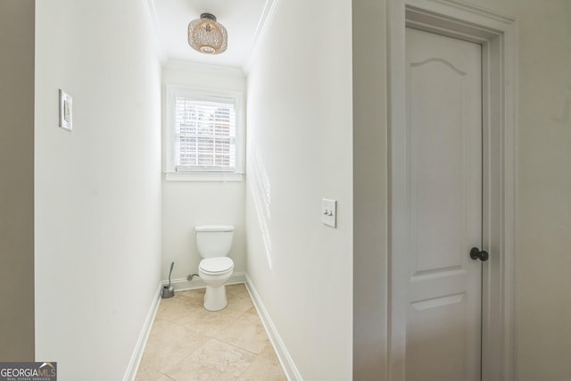 bathroom with toilet and crown molding