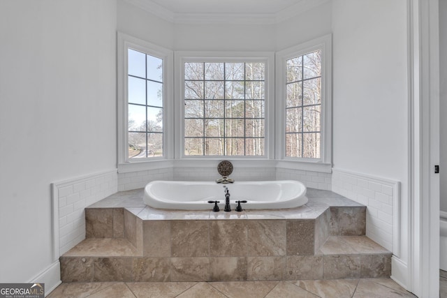 bathroom with tile patterned floors, tiled bath, crown molding, and plenty of natural light