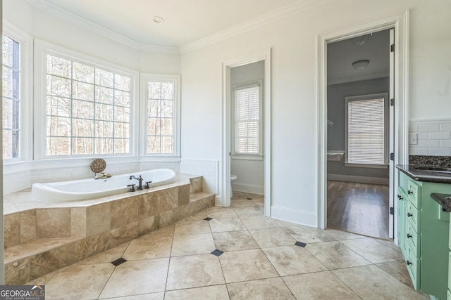 bathroom with toilet, vanity, tile patterned floors, and crown molding