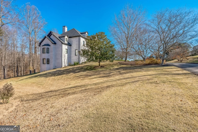 view of property exterior with a lawn