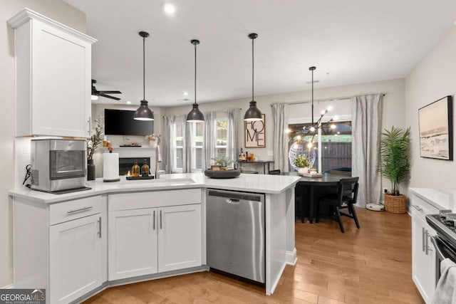 kitchen with stainless steel appliances, sink, and white cabinets