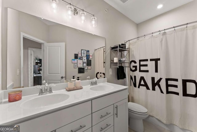 bathroom featuring vanity, a shower with shower curtain, and toilet