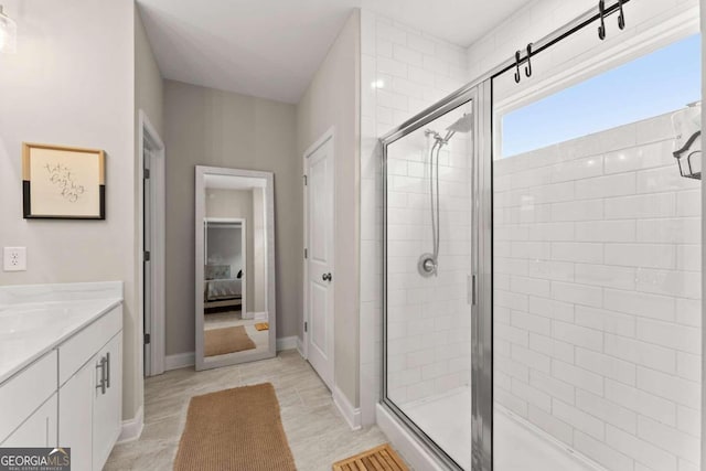 bathroom with vanity, an enclosed shower, and tile patterned flooring