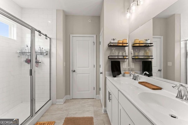 bathroom with vanity, tile patterned floors, and a shower with shower door