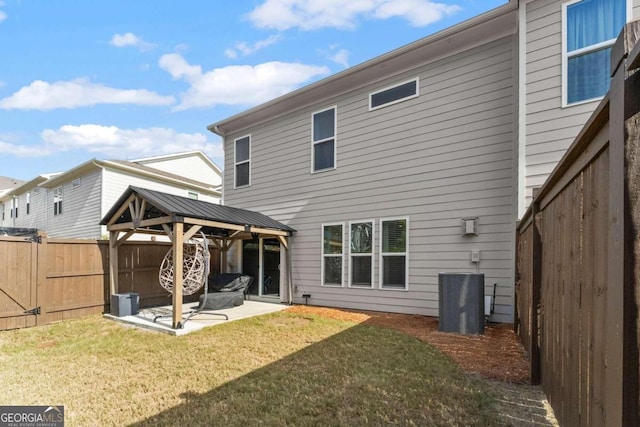 rear view of house featuring a patio, a yard, cooling unit, and a gazebo