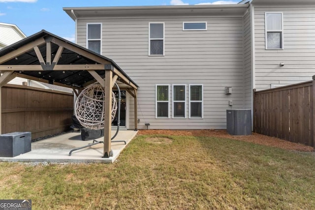 back of property featuring a yard, a gazebo, a patio, and central AC unit