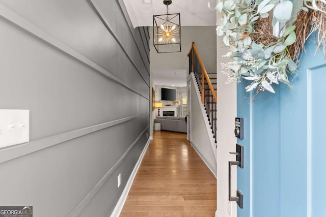 entrance foyer featuring hardwood / wood-style flooring and a chandelier