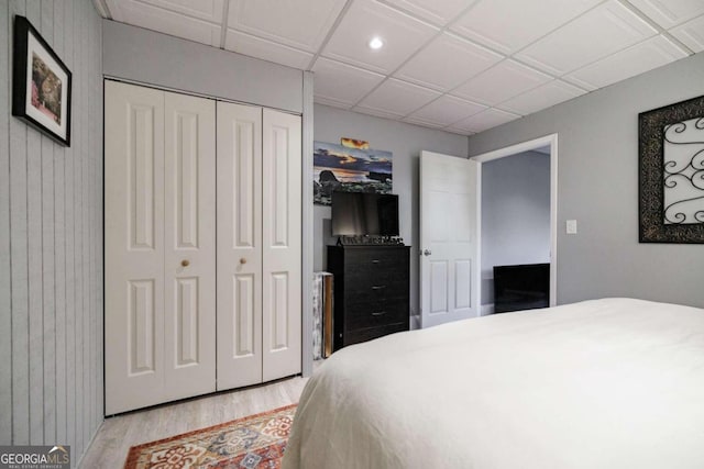 bedroom with light wood-type flooring and a closet