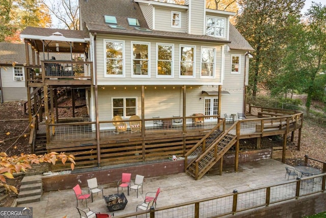 back of house with french doors, an outdoor fire pit, and a wooden deck