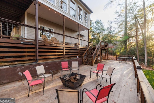 view of patio / terrace with a deck and an outdoor fire pit