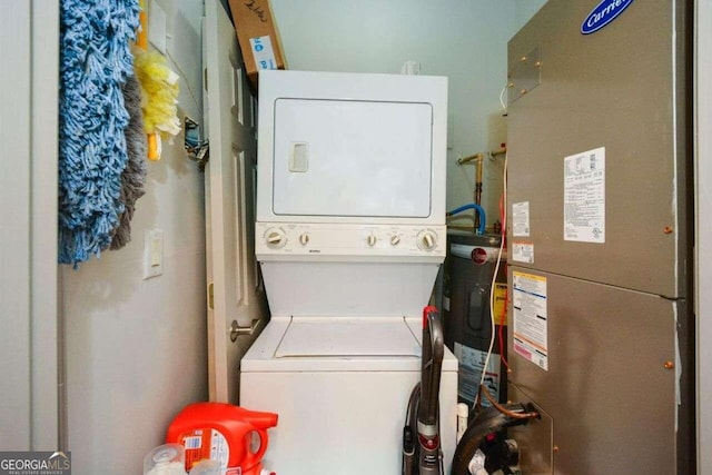 laundry room featuring stacked washer / dryer and heating unit