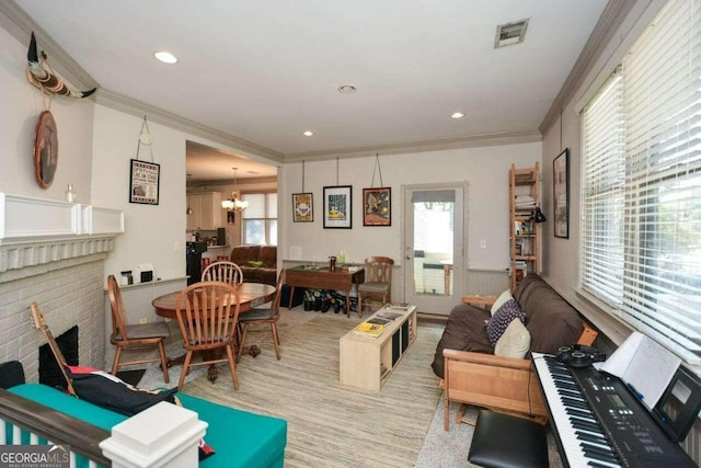 living room featuring plenty of natural light, crown molding, and a brick fireplace