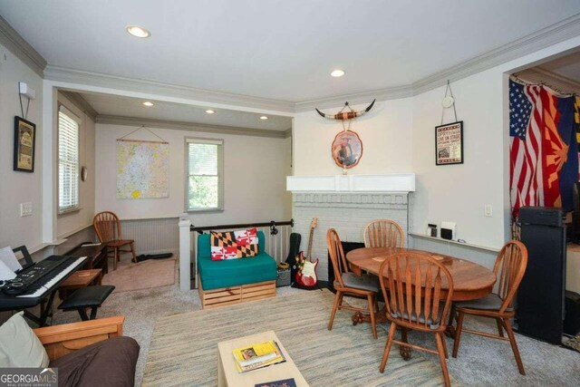 dining room with radiator heating unit, light colored carpet, and ornamental molding