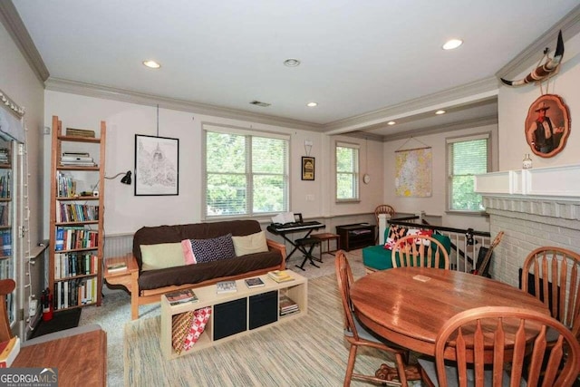 dining room featuring light carpet, a fireplace, and ornamental molding