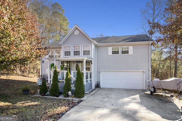 view of front property with covered porch and a garage