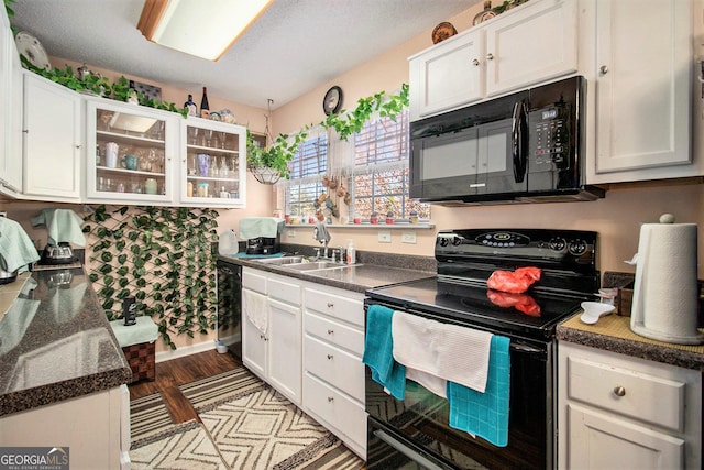 kitchen with white cabinetry, sink, light hardwood / wood-style flooring, a textured ceiling, and black appliances