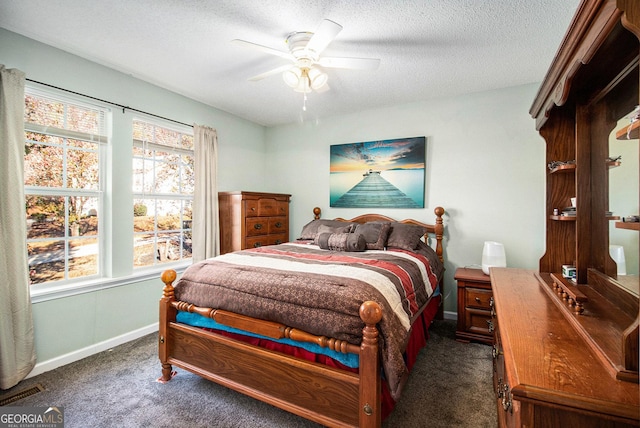 carpeted bedroom featuring a textured ceiling and ceiling fan