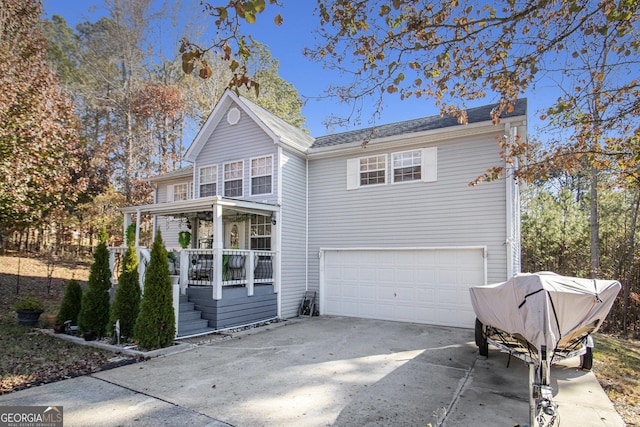 front of property featuring covered porch and a garage