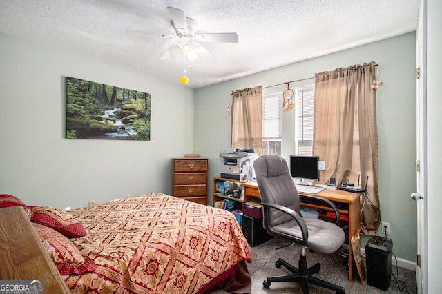 bedroom featuring a textured ceiling, carpet floors, and ceiling fan