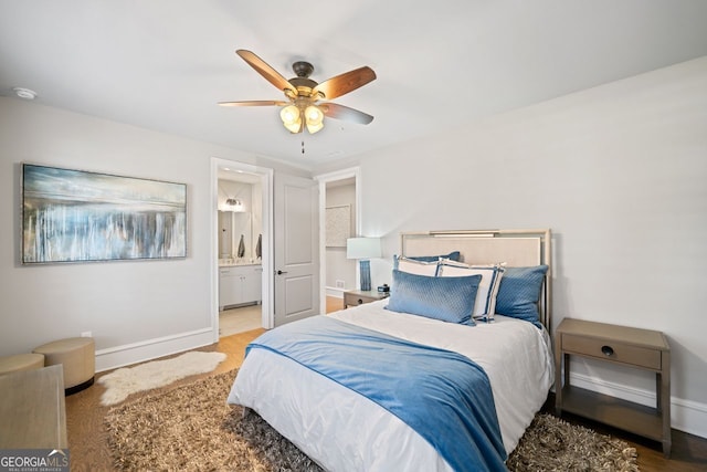 bedroom featuring hardwood / wood-style floors, ceiling fan, and ensuite bathroom