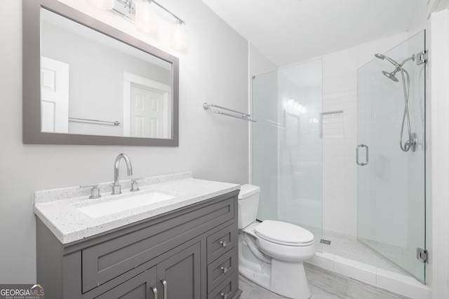 bathroom featuring vanity, toilet, and walk in shower