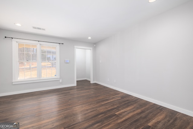 unfurnished room featuring dark wood-type flooring