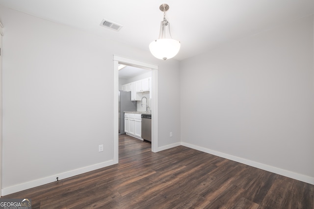 empty room with dark hardwood / wood-style floors and sink