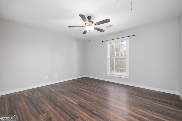 spare room featuring dark hardwood / wood-style floors and ceiling fan