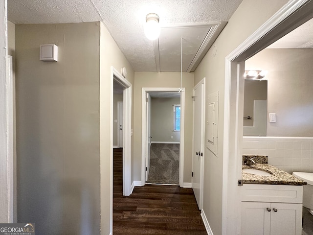 1737 Mckenzie Dr, Decatur, GA 30032 - hallway featuring attic access, dark wood finished floors, and a textured ceiling
