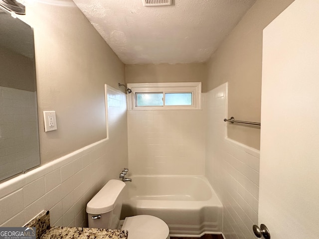1737 Mckenzie Dr, Decatur, GA 30032 - bathroom featuring tile walls, shower / bath combination, and a wainscoted wall