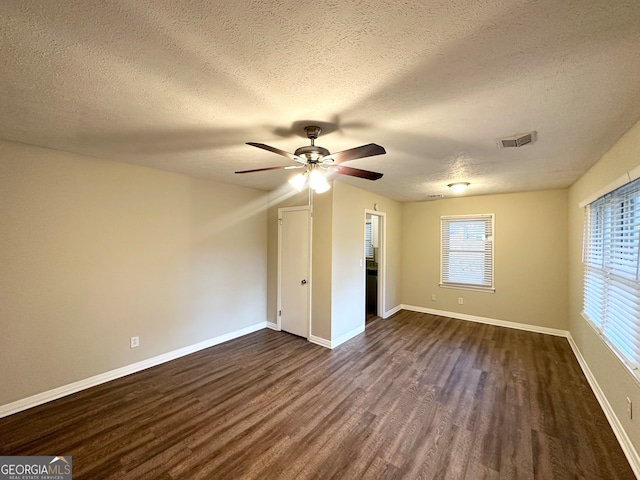 unfurnished bedroom featuring ceiling fan, dark hardwood / wood-style flooring, and a textured ceiling