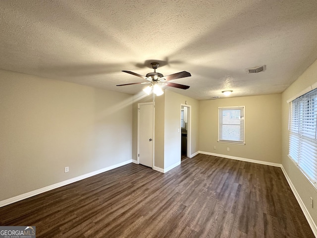 1737 Mckenzie Dr, Decatur, GA 30032 - unfurnished bedroom with dark wood-style flooring, a textured ceiling, and a ceiling fan