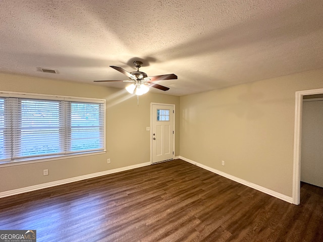 foyer featuring a textured ceiling, ceiling fan, and dark wood-type flooring