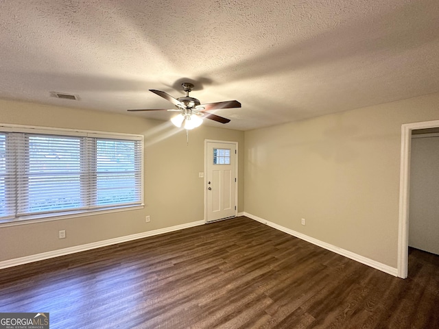 1737 Mckenzie Dr, Decatur, GA 30032 - foyer entrance featuring dark wood-type flooring, ceiling fan, and a textured ceiling