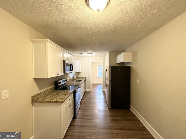 1737 Mckenzie Dr, Decatur, GA 30032 - kitchen featuring stainless steel appliances, a textured ceiling, white cabinetry, dark wood-type flooring, and stone countertops
