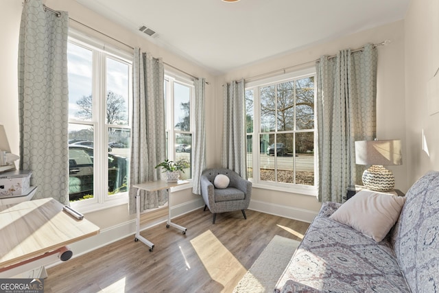 sunroom featuring visible vents and a wealth of natural light