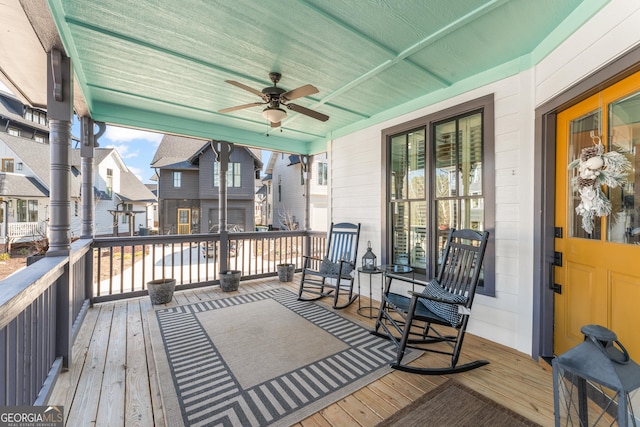 deck with ceiling fan and covered porch