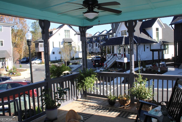 exterior space with a residential view and a ceiling fan