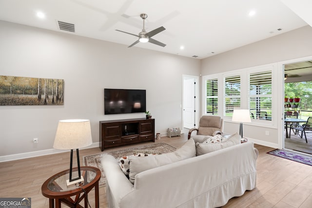 living room featuring ceiling fan and wood-type flooring