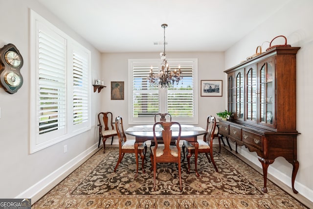 dining area featuring an inviting chandelier