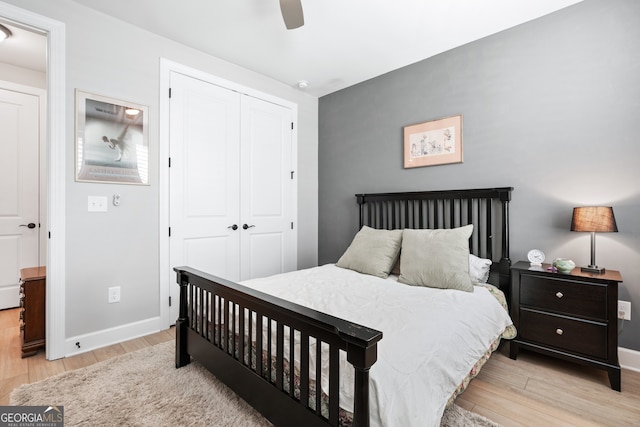 bedroom featuring ceiling fan, light wood-type flooring, and a closet