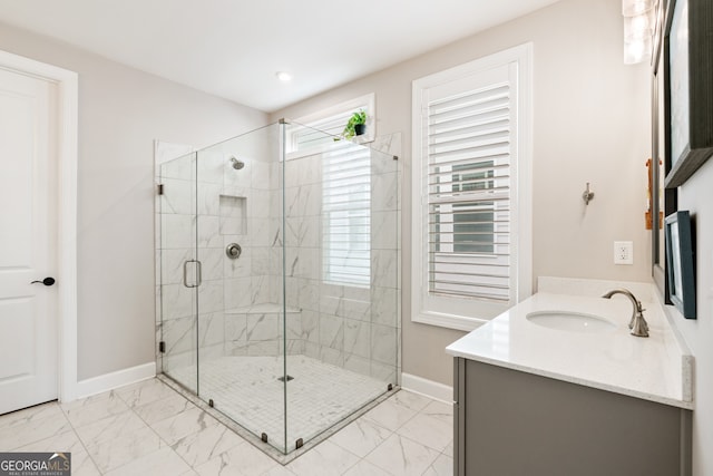 bathroom with vanity and a shower with door