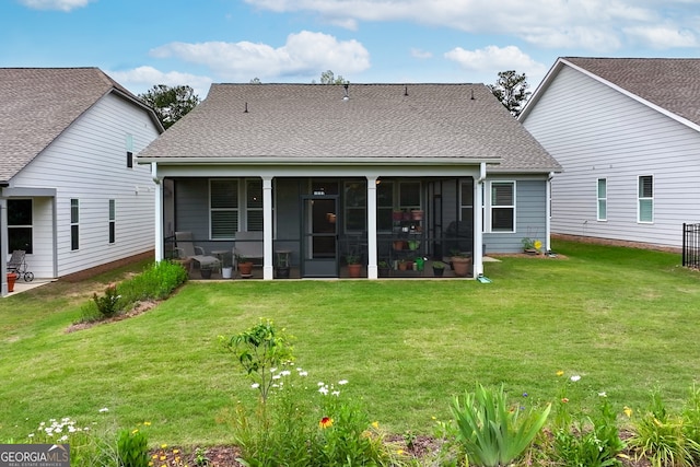 back of property featuring a sunroom and a lawn