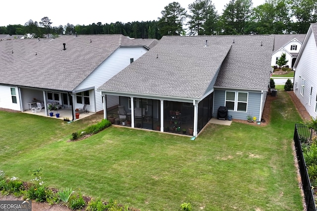 back of house with a sunroom, a yard, and a patio