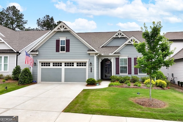 craftsman inspired home with a front yard and a garage