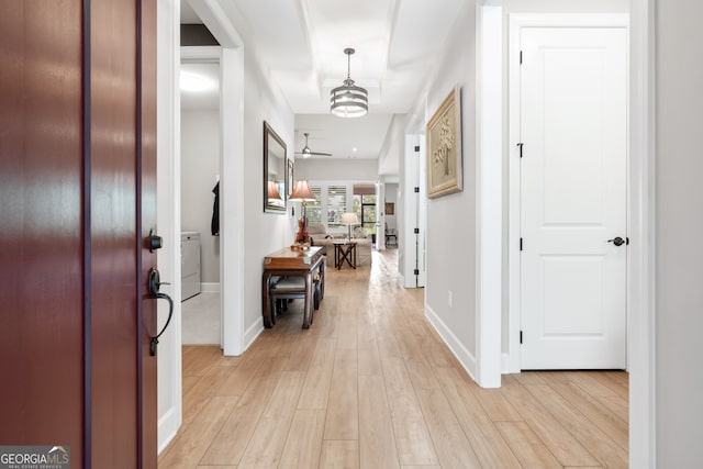 corridor with light hardwood / wood-style floors