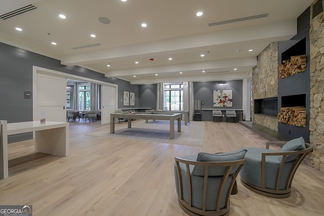 playroom with a fireplace, light hardwood / wood-style flooring, and pool table